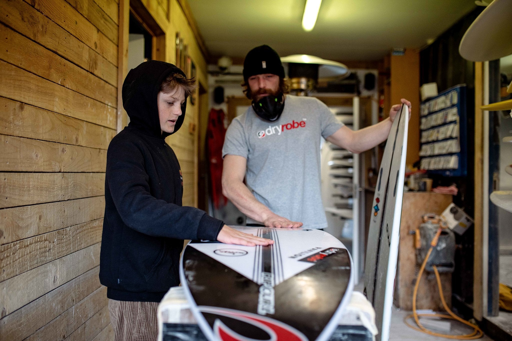 Lukas and Ben Skinner working on a surf board