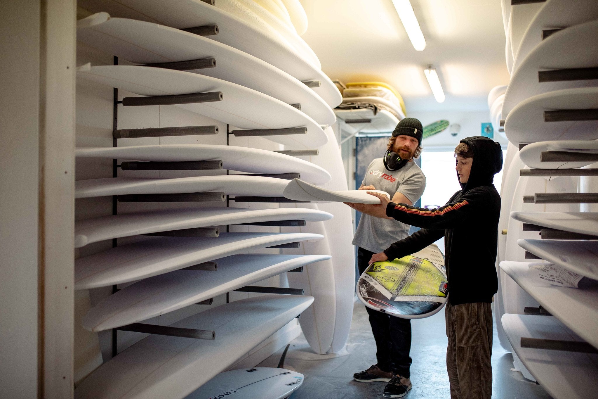 Ben and Lukas Skinner looking at surfboards