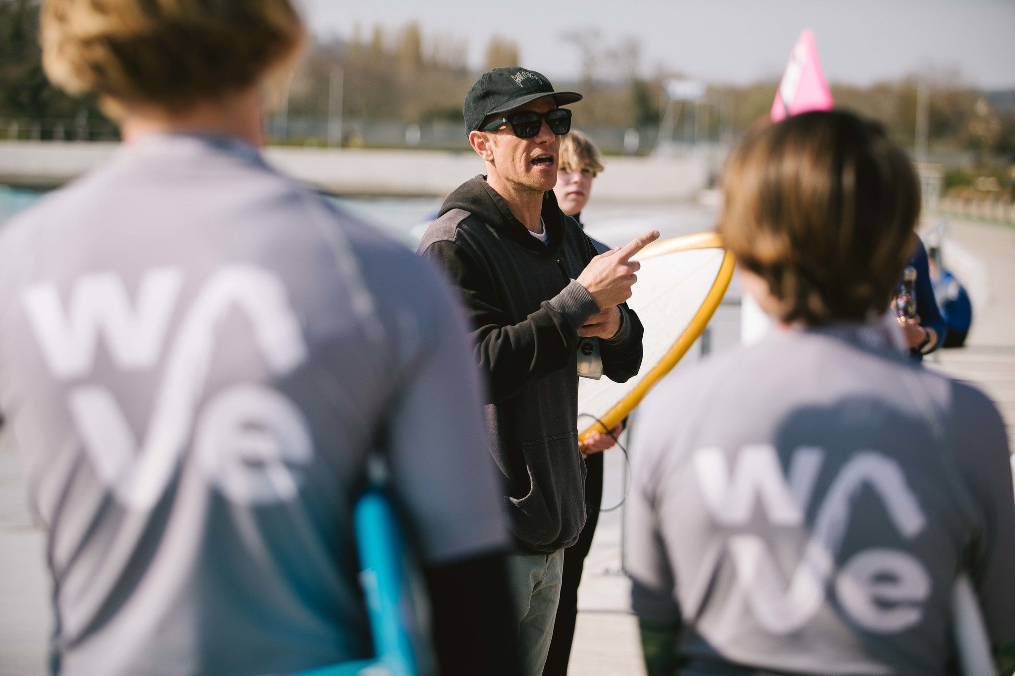 Team England coach instructing young surfers at The Wave