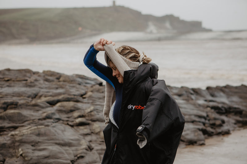 Sophie Hellyer changing in dryrobe on the beach
