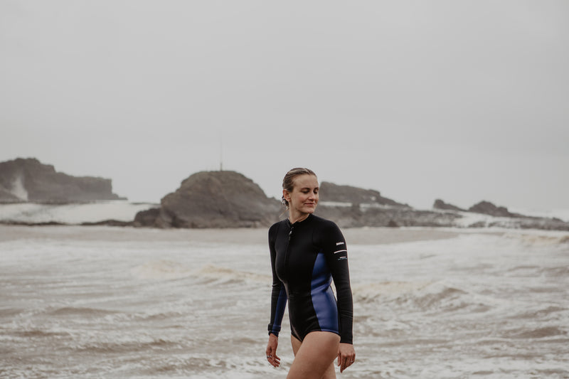 Sophie Hellyer walking on the beach in a swimming costume
