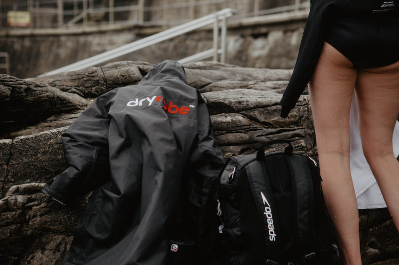 A dryrobe Advance laid on a rock on the beach