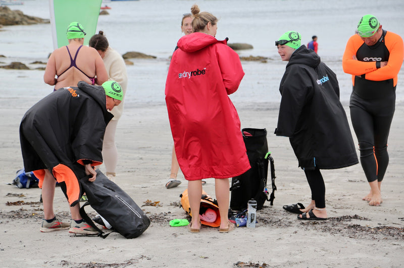 Swimmers getting ready to go in the sea on the beach 