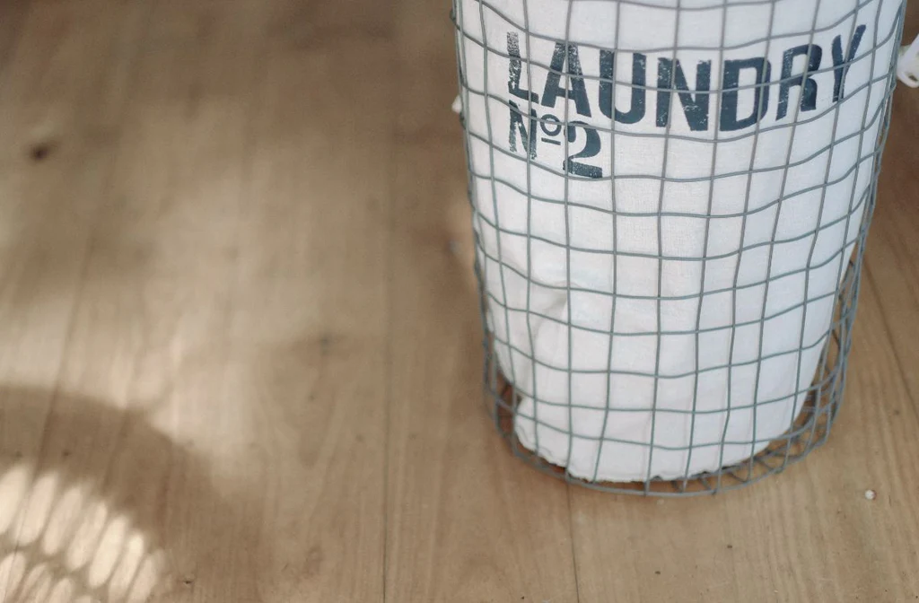 Laundry basket on wooden floor.