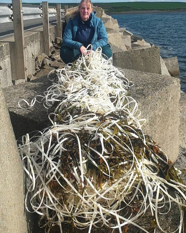 Alison gathers plastic waste from the ocean