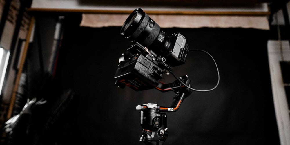 A filmmaking camera stabilizer for DSLR can hold various photogears on it, such as the cameras, v lock battery power supply, monitor, wireless transmission, etc.