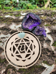 Tree trunk with on top our wooden heart chakra symbol and Purple Quartz Geode
