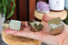 Pyrite cubes in hand