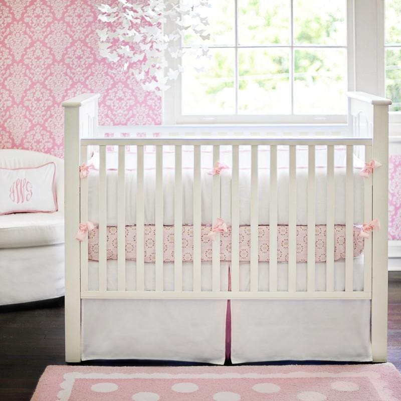 white and pink crib