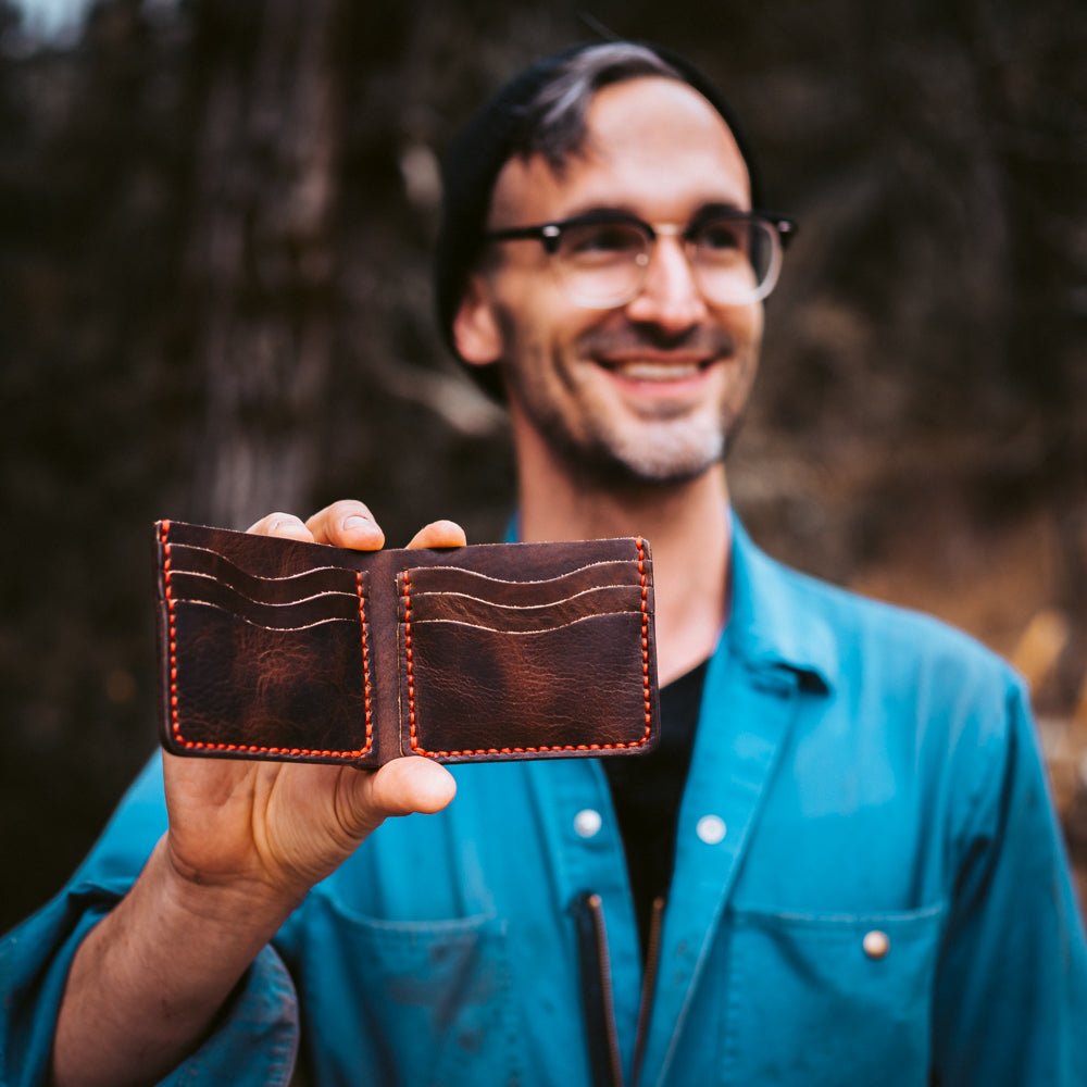 happy man holding a leather wallet
