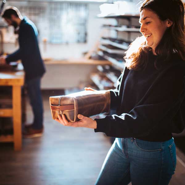 Meghan holding a dopp kit