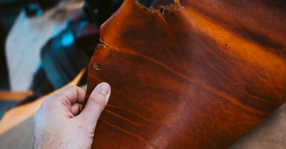 full-grain leather with visible natural markings like scratche