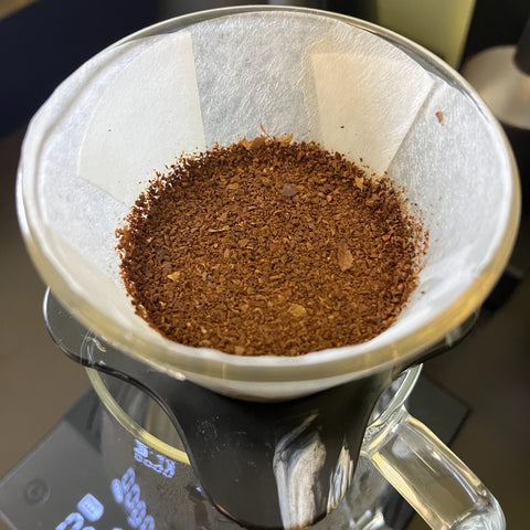 Tamping coffee bed for pour over How to slow down your draw down with out touching grind size Basic Barista Australia Melbourne coffee brewing gear 