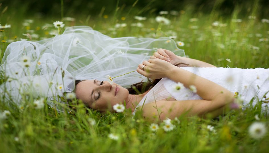 bride laying in grass