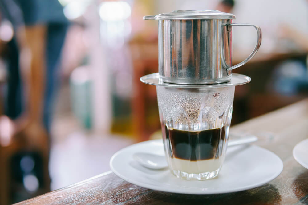 Hot milk coffee dripping from Phin filter, a Vietnam coffee process