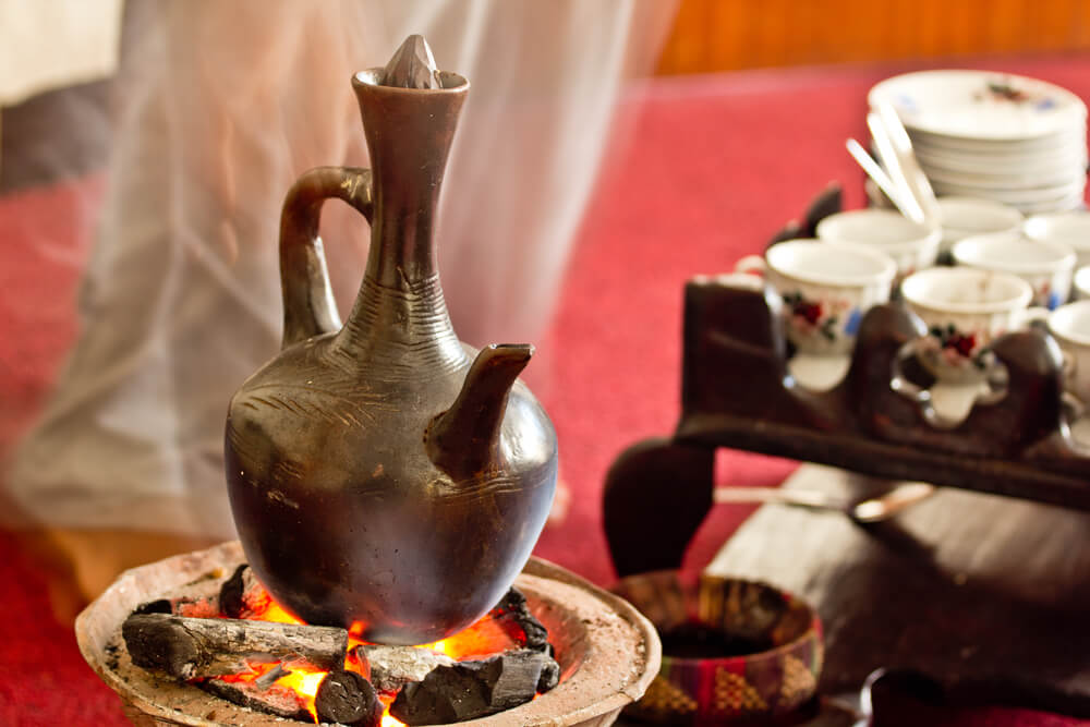 Making coffee the Ethiopian traditional way using coal with a Jebena 