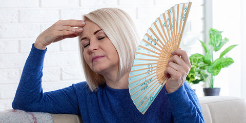 Woman Going Through Menopause Fanning Herself