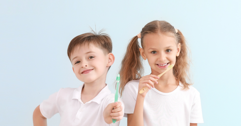 Happy children brushing their teeth