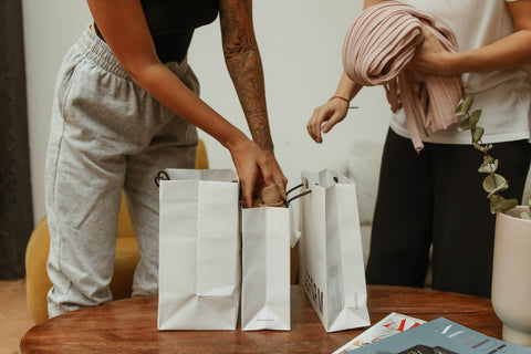 Women packing paper bags.