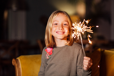 child holding a sparkler