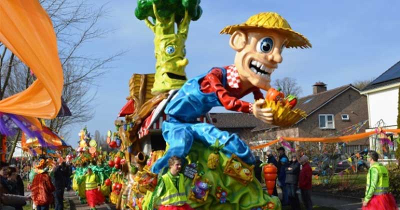 Photo of Dutch carnival parade, big paper-mache man and broccoli on a wagon