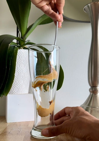 peanut butter protein smoothie in a tall glass