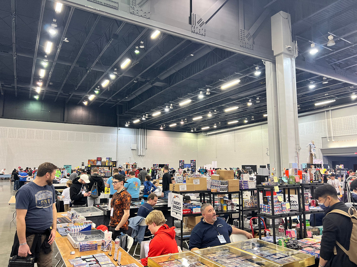 A group of people at a sports card expo table