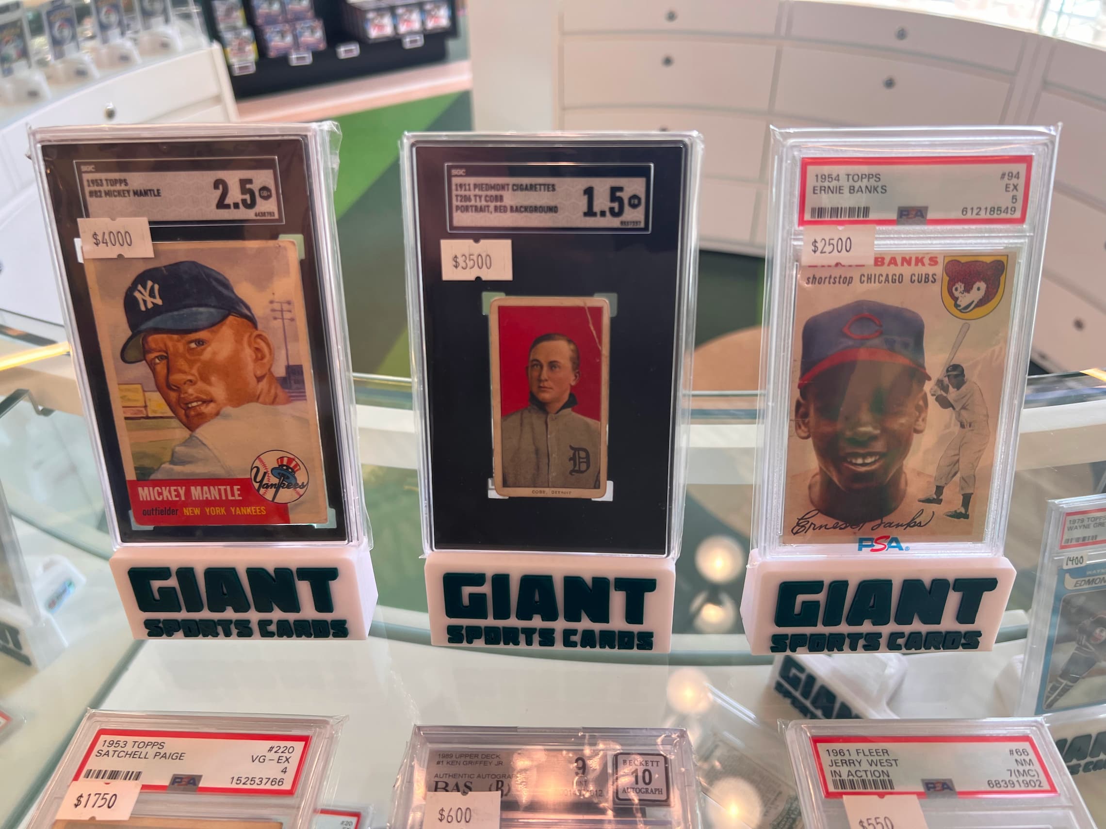 three sports cards standing upright