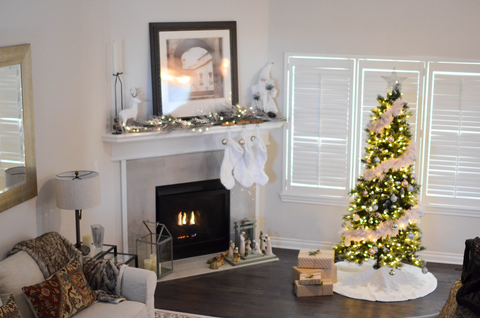 fireplace with Christmas decor surrounding in and around the living area