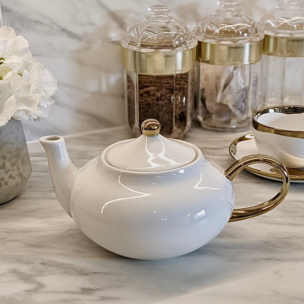 gold and white tea kettle