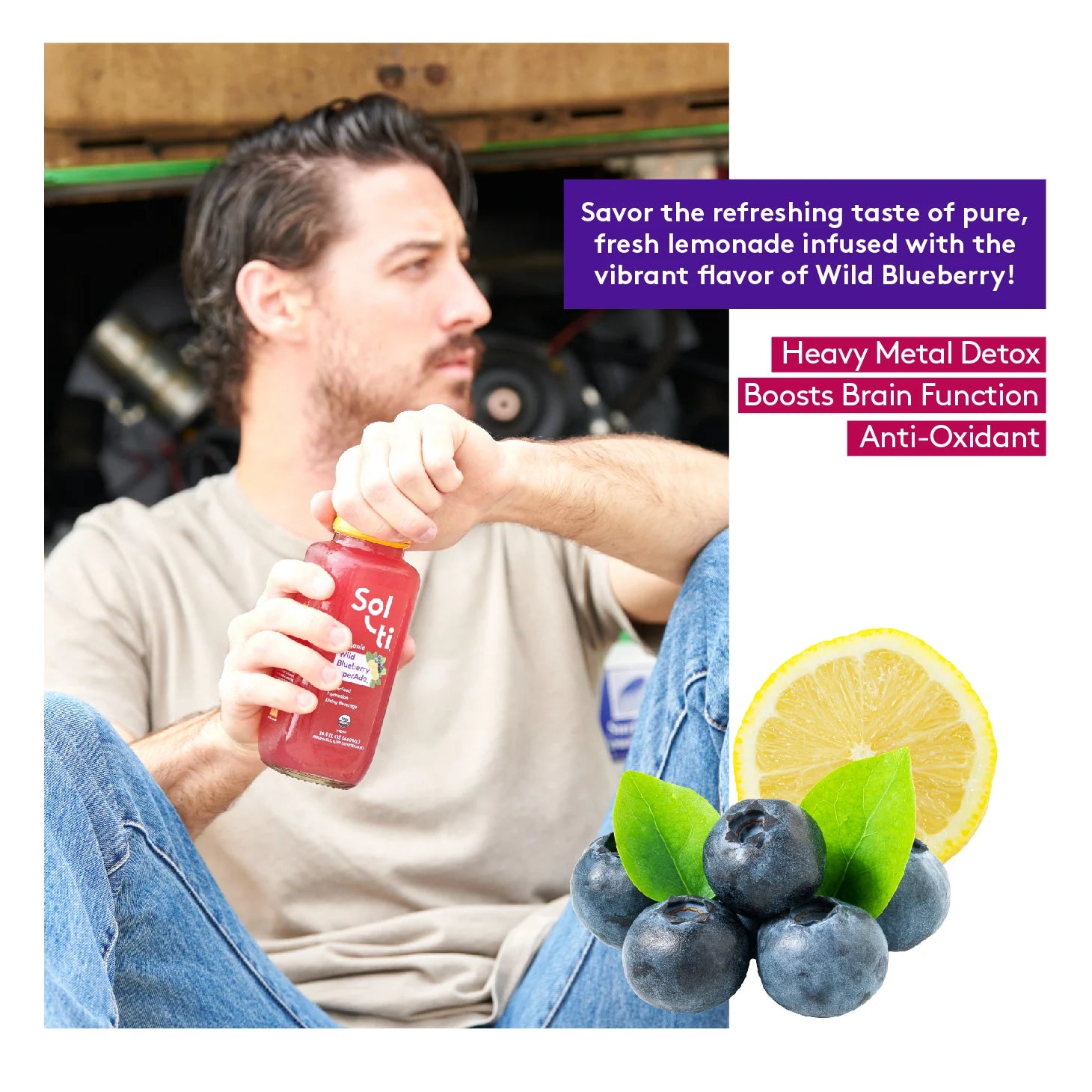 a man sitting down with a bottle of Wild Blueberry SuperAde, next to a slice of lemon and wild berries