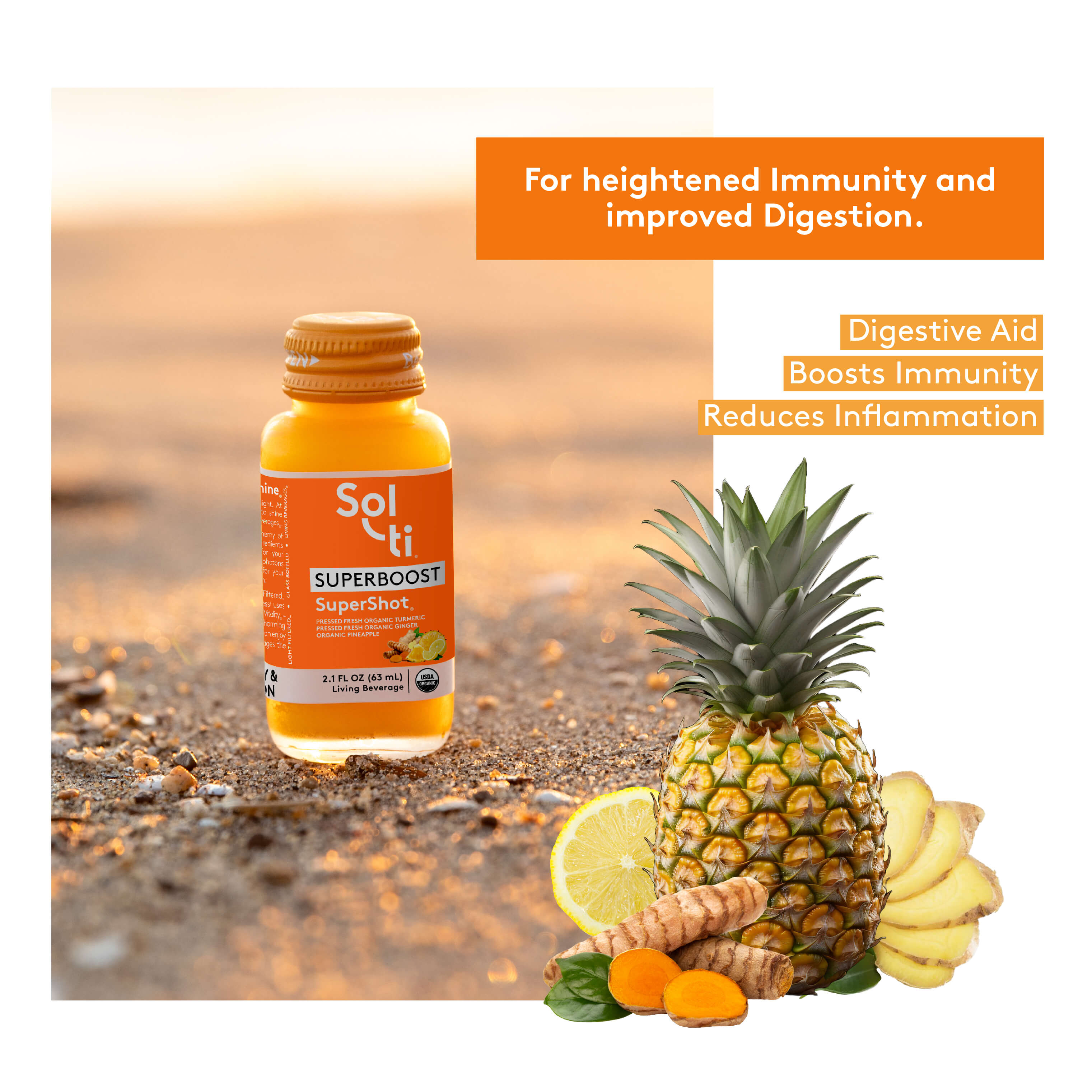 a bottle of SUPERBOOST SuperShot next to with a pineapple, turmeric root, ginger slices and a slice of lemon