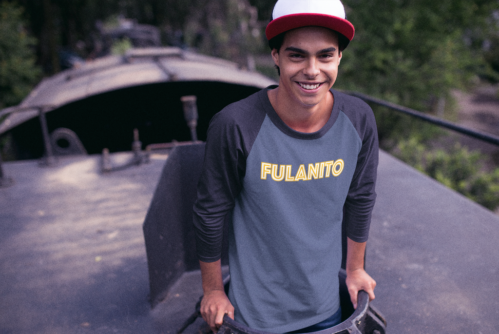 image of young man wearing a blue raglan that says fulanito on the front of the t-shirt