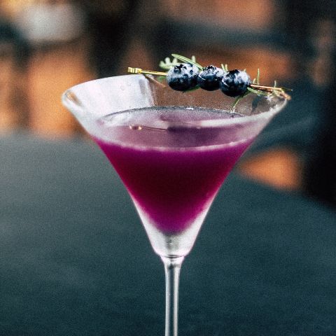Cocktail garnished with blueberries