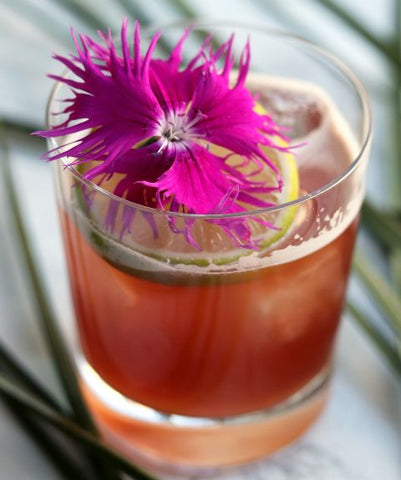 Cocktail served with a garnish of edible flowers
