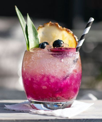 Cocktail served with pineapple frond garnish