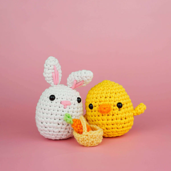 A crocheted rabbit with a basket and carrot.