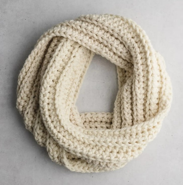 A white ribbed scarf on a gray background