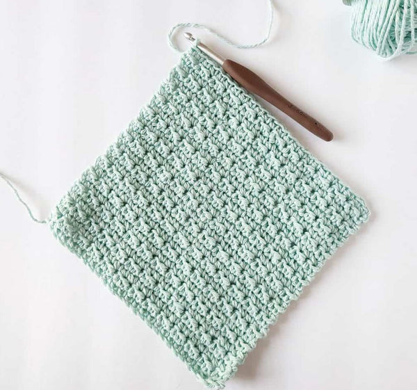 A green washcloth on a white background