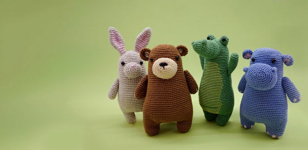 Bunny, bear, crocodile and hippo intermediate crochet amigurumi plushies standing together