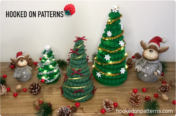 Crochet Christmas trees of varying sizes with festive decorations