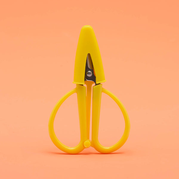 Yellow Wee Woobly Scissors on an orange background