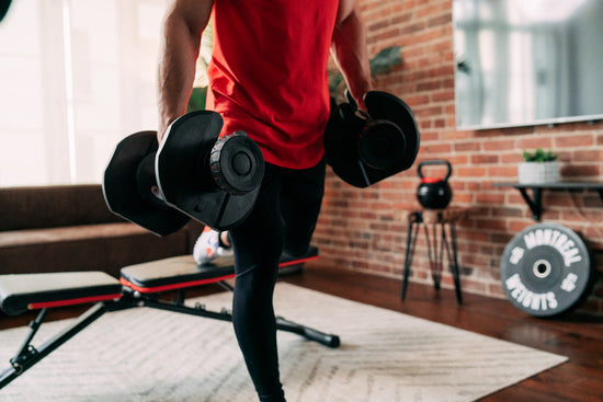 Man doing bench lunges with adjustable dumbbells