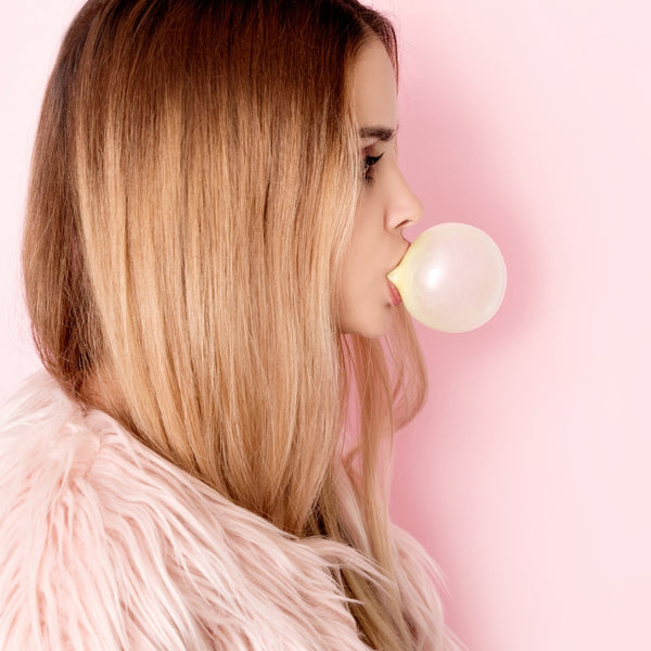 Woman Blowing a BubbleGum Bubble | Thryv Organics | DallasCBD