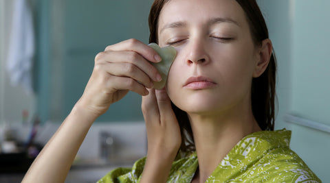 girl using gua sha face tool