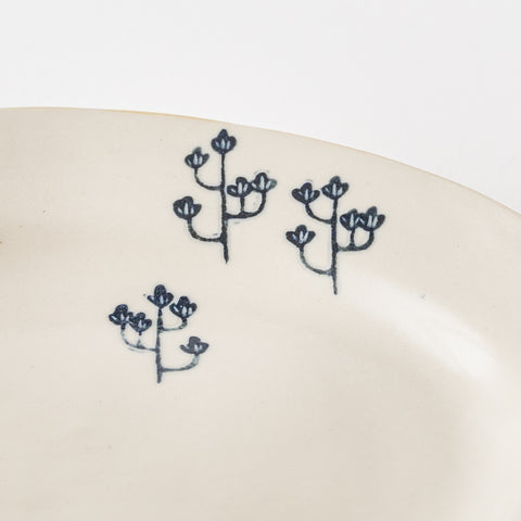 Naoko Yoshimura's scraped oval plate with a warm wooden pattern