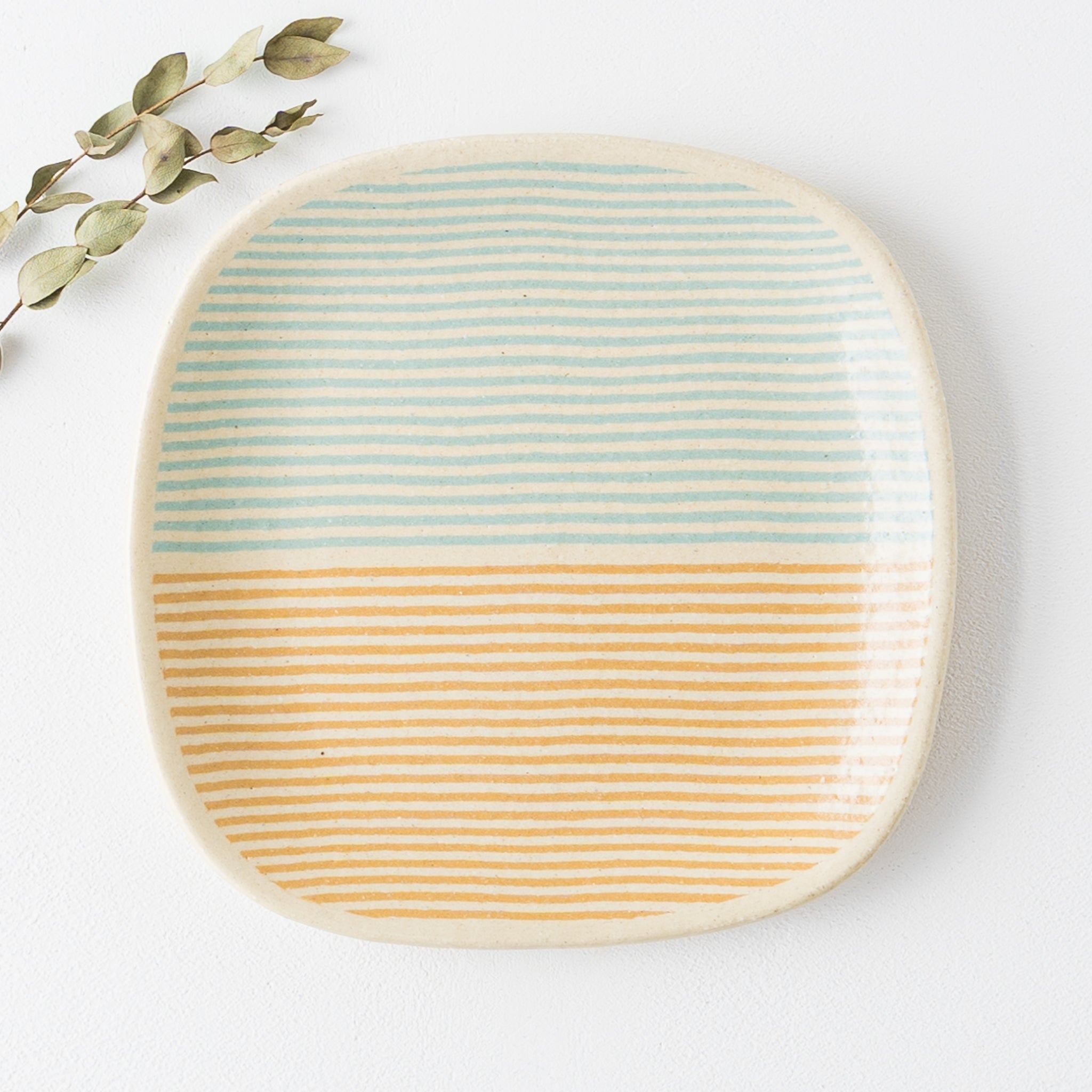 Hanako Sakashita's four-sided plate with cute striped pattern of turquoise and bright yellow