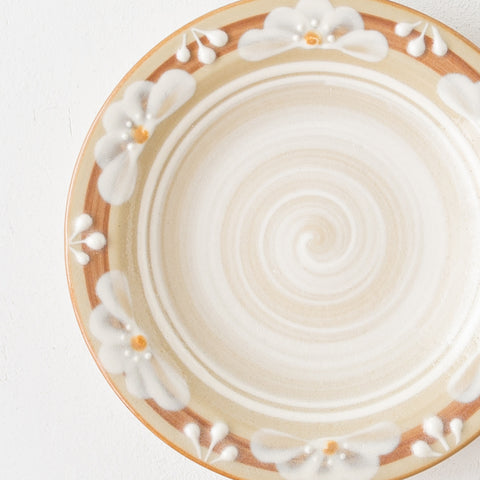 A plate by Adachi no Potari with a lovely retro-modern floral pattern.