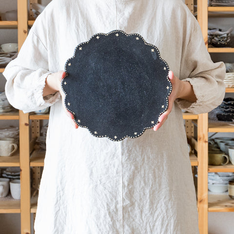 Aiko Takasu's flat plate with warm black and cute patterns.