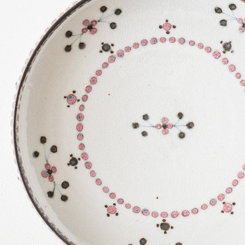 A 7-inch deep dish from a Tosai kiln with a cute red floret design